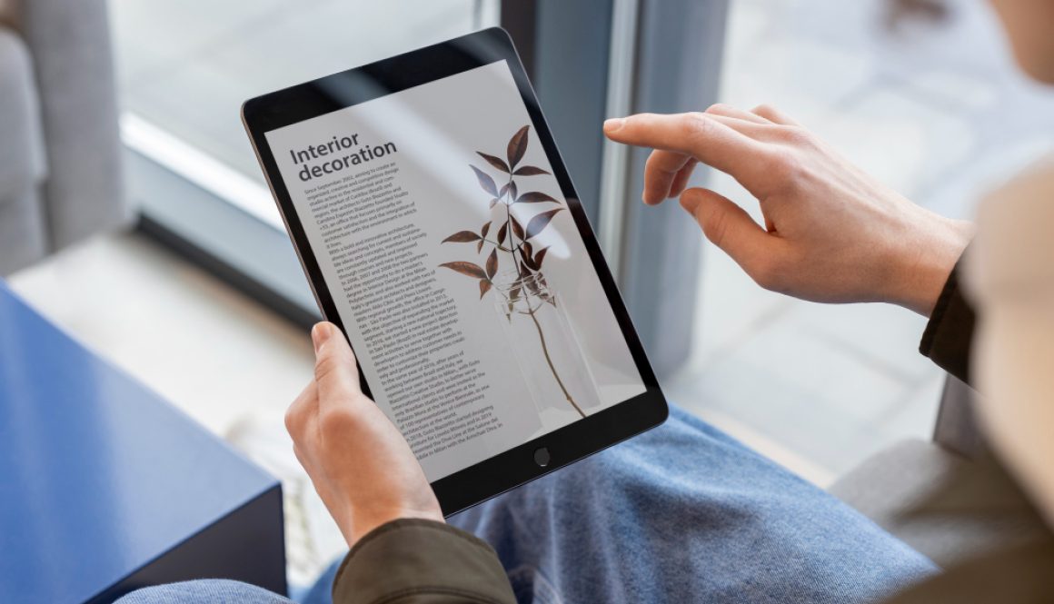 person-reading-online-magazine-using-digital-device